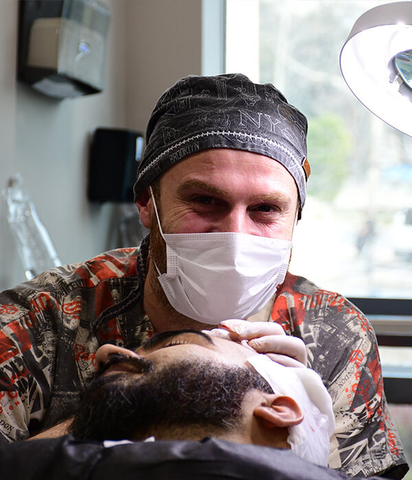 Surgeon performing precision hair restoration procedure